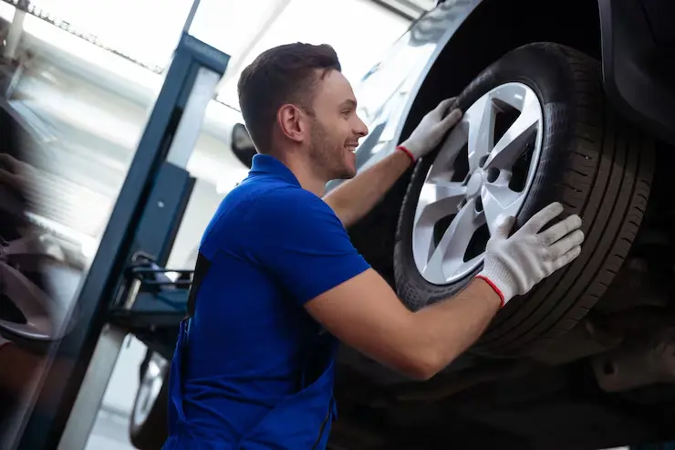 Tire technician fitting a wheel